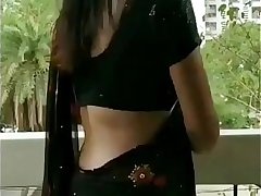 Harshita in saree standing in balcony. soft tease